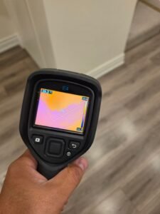 CPR24 Restoration using thermal imaging to inspect an interior wall corner for potential moisture intrusion in Oakville.